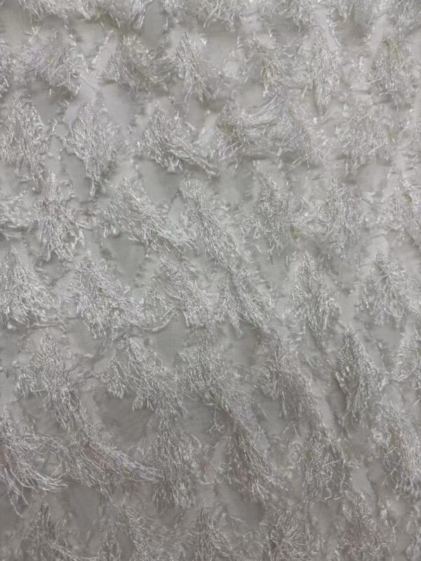 Close-up of silver lace fabric with intricate floral patterns, ideal for wedding dresses and evening gowns.