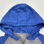 Close-up of a blue and gray hoodie with a zipper and drawstrings, casual streetwear style.
