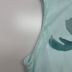 Light blue sleeveless T-shirt with a subtle leaf print, perfect for casual wear and summer outfits.