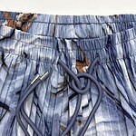 Close-up of blue patterned swim shorts with adjustable drawstring for a comfortable fit.