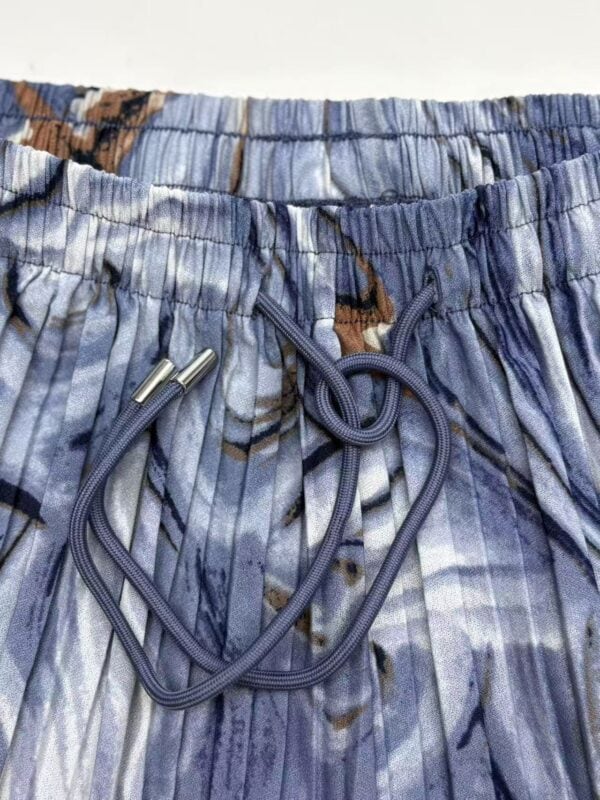 Close-up of blue patterned swim shorts with adjustable drawstring for a comfortable fit.