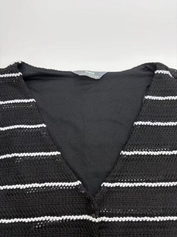 Close-up of a black and white striped knit sweater with a V-neck, suitable for casual or office wear, showcasing textured fabric and classic pattern.