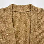 Close-up of a beige knitted cardigan with a V-neck design, showcasing textured fabric and soft material, perfect for casual or office wear.