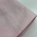 Close-up of soft pink fabric with smooth texture, ideal for fashion and clothing design projects.