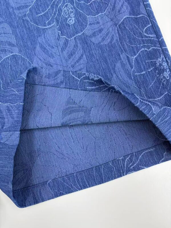 Close-up of blue linen fabric with floral pattern, ideal for stylish clothing and accessories.