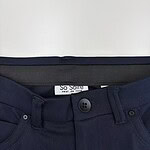 Close-up of navy blue women's trousers with button and zipper closure, showcasing a sleek and professional style suitable for office wear or formal occasions.