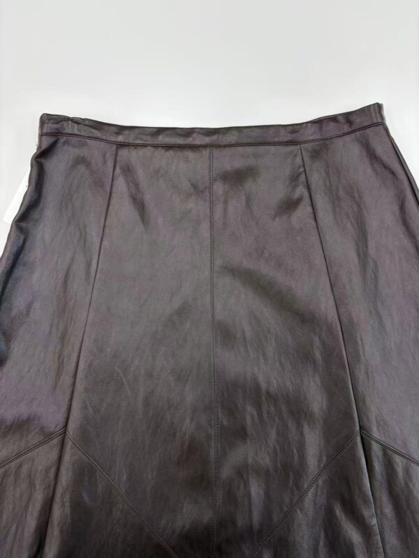 High-quality black leather skirt with detailed stitching, perfect for stylish and professional outfits.