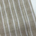 Close-up of beige fabric with white vertical stripes, suitable for clothing or home decor.