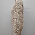 Beautiful beige crochet dress with intricate lace patterns, perfect for summer or special occasions, displayed on a mannequin.