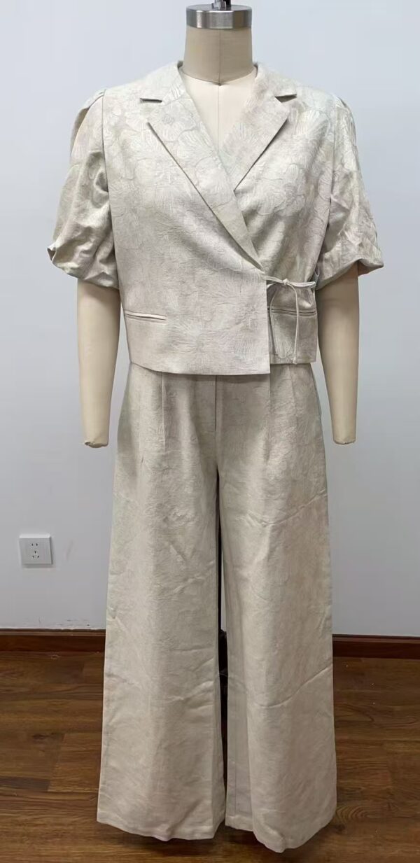 Stylish women's linen suit with a tailored blazer and wide-leg pants, perfect for casual or semi-formal occasions, showcasing high-quality fabric and modern design.