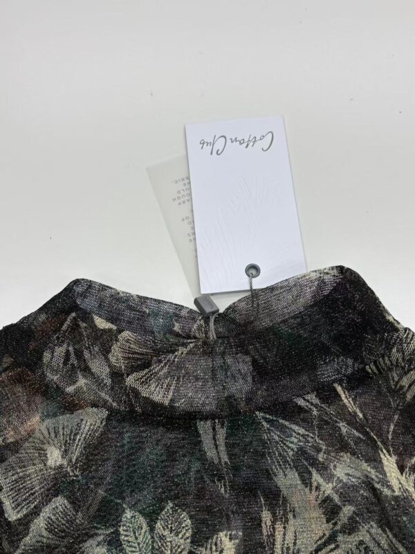 Close-up of a stylish women's skirt with a dark floral pattern, displayed on a white background with a price tag attached.