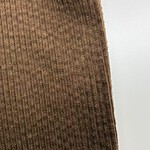 Close-up of brown ribbed fabric showing texture and vertical lines, ideal for fashion and textile product display.