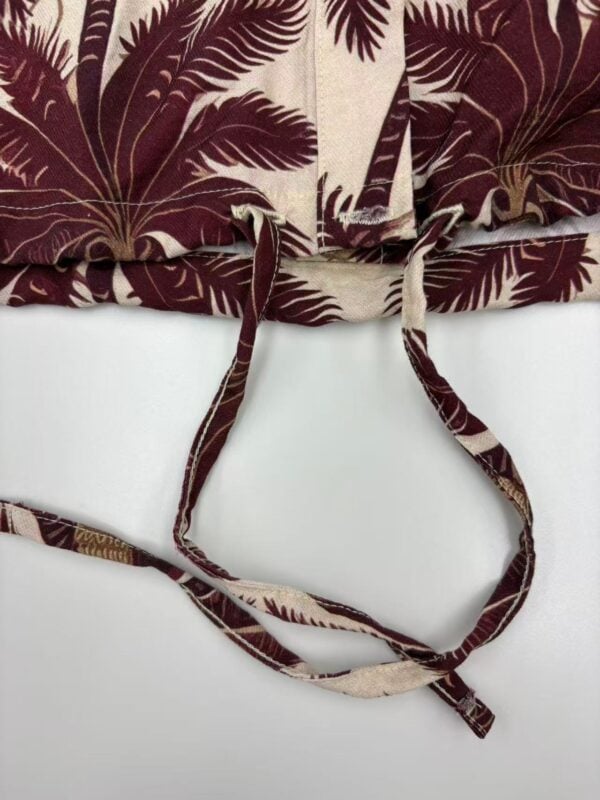 Close-up of a tropical leaf print drawstring bag with adjustable straps, perfect for casual summer outings and beach trips.