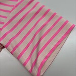 Close-up of pink and beige striped fabric, showcasing the pattern and texture, ideal for fashion or textile product SEO.