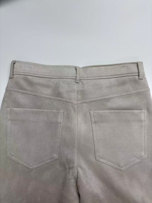 Close-up of beige casual pants showing back pockets and waistband, suitable for everyday wear and fashion styling.