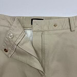 Close-up of beige casual men's pants showing zipper, button, and belt loops, suitable for everyday wear and stylish comfort.