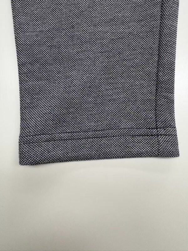 Close-up of black and white textured fabric, suitable for fashion or upholstery projects.