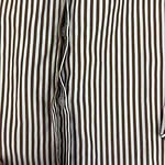 Close-up of a men's dress shirt with vertical brown and white stripes, buttoned down the front, showcasing classic formal wear style.
