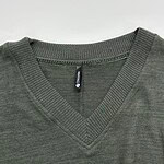 Close-up of men's olive green V-neck sweater made from soft fabric, featuring ribbed neckline and seamless design, ideal for casual and professional wear.