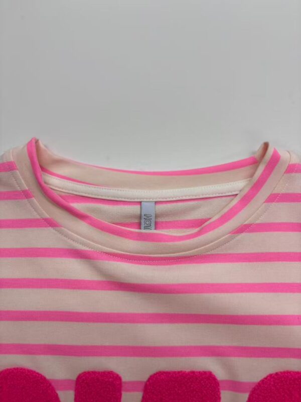 Close-up of a pink and beige striped women's T-shirt with a round neckline, showcasing casual fashion suitable for everyday wear.