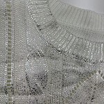 Close-up of a silver sequin top with intricate detailing, perfect for stylish occasions and evening wear.