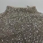 Close-up of a silver sequin dress with a high neckline, perfect for evening events and parties, showcasing sparkling embellishments and luxurious fabric.