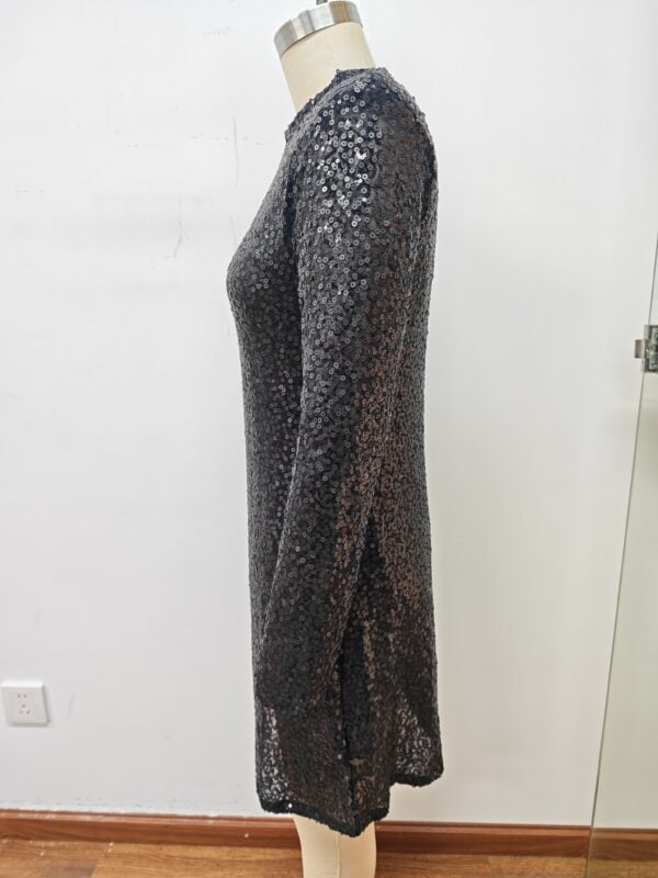 Long black sequin dress with full sleeves, perfect for evening events and parties, displayed on a mannequin against a plain white background.