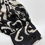 Close-up of a stylish black and white patterned sleeve with buttoned cuff, perfect for fashion-forward outfits.
