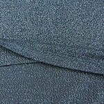 Close-up of shimmering teal fabric with tiny reflective particles, ideal for stylish clothing and accessories.
