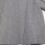 Close-up of a tailored grey business blazer for women, showcasing the fabric texture and professional style, ideal for office wear and formal occasions.