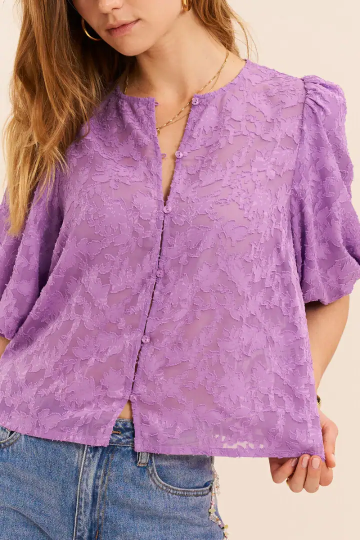 Stylish lavender lace blouse with puff sleeves and a button-up front, perfect for casual or semi-formal occasions.