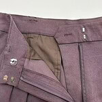 Close-up of stylish mauve women's trousers with zipper and button closure, showcasing high-quality fabric and tailored fit, perfect for casual or formal wear.