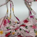 Pink floral summer dress with adjustable shoulder straps and a bow at the front, perfect for warm weather and casual outings.