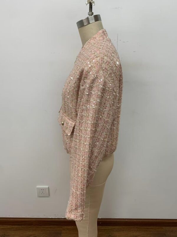 Stylish pink tweed jacket with intricate detailing, perfect for fashionable women. Showcased on a mannequin against a plain white background.