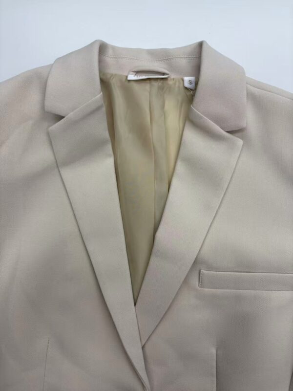 Stylish beige blazer with a classic lapel collar, tailored fit, and sleek design, perfect for professional or casual wear.