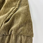 Close-up of soft, brown velvet fabric with a smooth texture and subtle sheen, ideal for high-end fashion and upholstery.