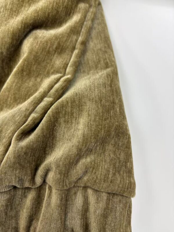 Close-up of soft, brown velvet fabric with a smooth texture and subtle sheen, ideal for high-end fashion and upholstery.