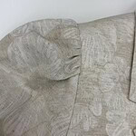 Close-up of a beige fabric sofa with textured cushions, perfect for a modern living room setting.