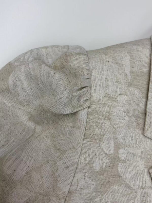 Close-up of a beige fabric sofa with textured cushions, perfect for a modern living room setting.