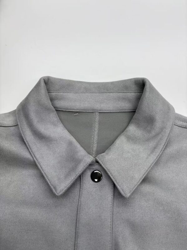 Close-up of a grey polo shirt with a buttoned collar, perfect for casual or semi-formal wear, showcasing high-quality fabric and modern design.