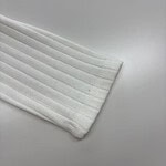 Close-up of a white ribbed sock showcasing its texture and fabric quality, ideal for casual or athletic wear.