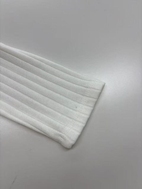 Close-up of a white ribbed sock showcasing its texture and fabric quality, ideal for casual or athletic wear.