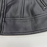 Detailed close-up of a black leather jacket showing texture, stitching, and zipper details for fashion and apparel SEO.
