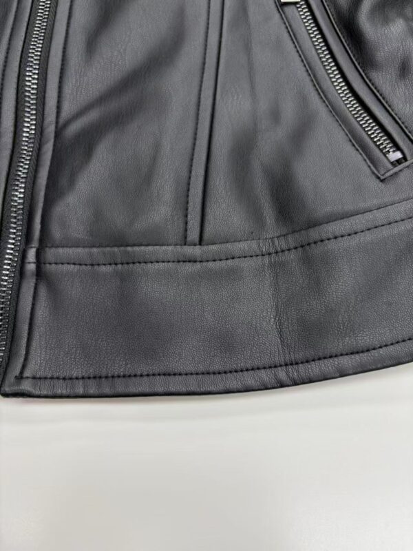 Detailed close-up of a black leather jacket showing texture, stitching, and zipper details for fashion and apparel SEO.