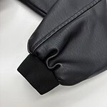 Close-up of a black leather jacket sleeve with ribbed cuff, showcasing high-quality material and craftsmanship.