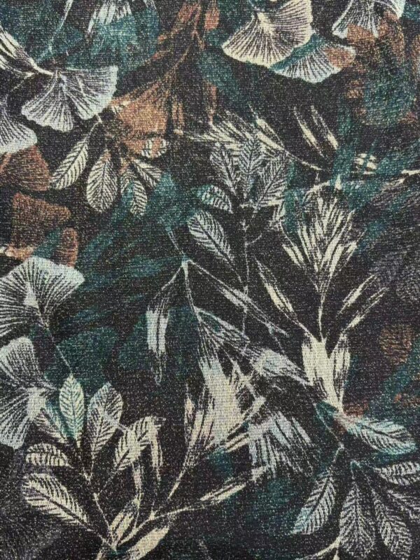 Close-up of tropical leaf pattern fabric featuring detailed white and beige leaves on a dark background, ideal for fashion and home decor.