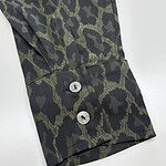 Close-up of men's dress shirt with leopard print pattern, featuring button cuffs and tailored fit, ideal for stylish formal or casual occasions.