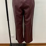 Stylish burgundy leather wide-leg pants with back pockets, perfect for fashion-forward women seeking a chic and comfortable look.