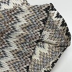 Close-up of tribal patterned fabric with intricate geometric designs in earthy tones, suitable for fashion and home decor.