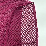 Bright pink crochet shawl with zigzag pattern, perfect for fashion and accessories, showcasing intricate craftsmanship and stylish design.